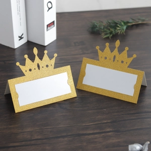 Glittering gold crown place cards for wedding tables with elegant cutout design