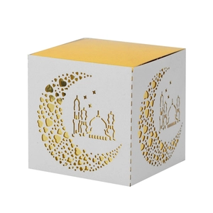 Macro detail of Eid Mubarak white candy box with golden lid and laser-cut mosque patterns