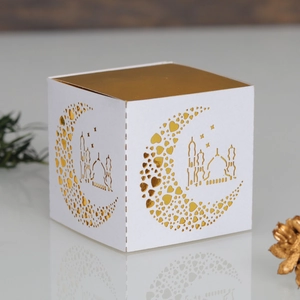 Detail of white Eid Mubarak candy box featuring golden crescent moon and mosque cutouts