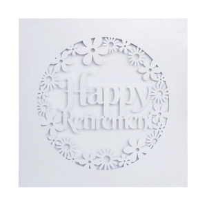 Detail of laser-cut pearl paper card with floral pattern and Happy Retirement text
