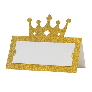 Macro shot of gold glitter crown place card with elegant laser cut hollow design for weddings