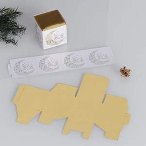 Laser-cut moon and mosque pattern on a luxury white and gold Ramadan gift box