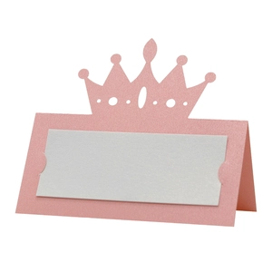 Detail of pink pearlescent place card with a hollow crown design and white inner sheet