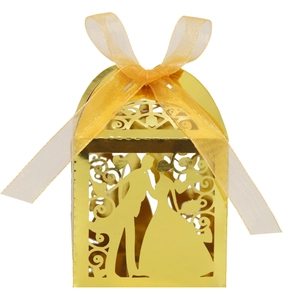 Detail showing the intricate laser-cut groom and bride silhouette on golden gift box
