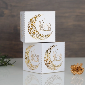 Laser-cut white gift boxes with gold crescent moon and architectural patterns for festivals