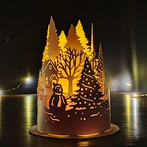DIY Christmas paper night light with cutout snowman and tree scene on wooden base