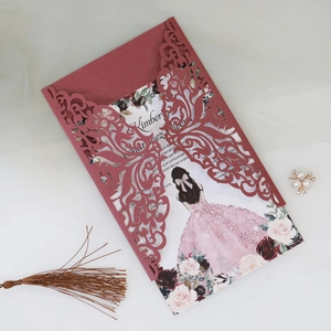 Detail of laser-cut burgundy invitation card with elegant floral inner page and soft tulle