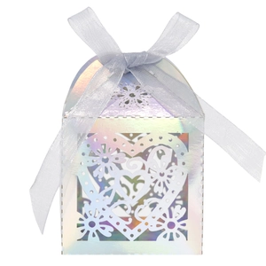 Close-up of laser-cut heart candy box with iridescent finish and blue silk ribbon bow