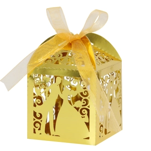 Golden laser-cut wedding favor box with bride and groom silhouette and ribbon tie
