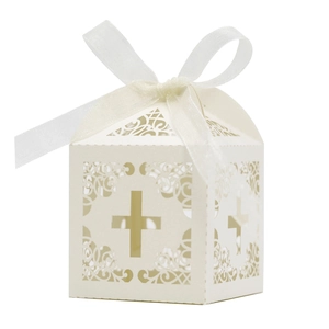 Laser-cut white cross favor box with intricate scrollwork and elegant white ribbon bow