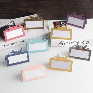 Close-up of laser-cut place cards with heart-shaped birds design in multiple colors