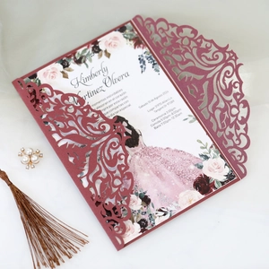 Detail of burgundy laser-cut invitation with floral inner card and silk tassel