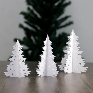 Set of 3 white 3D laser-cut paper Christmas tree table ornaments with hollow round patterns