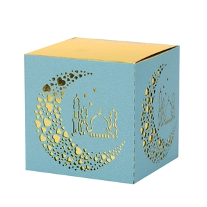 Detail of laser-cut moon and mosque pattern on light blue and gold gift box