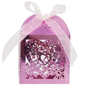 Pink laser-cut candy box with intricate heart pattern and white ribbon for wedding party