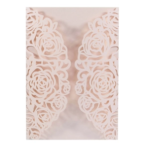 Detail of laser-cut rose floral pattern on pearlescent paper wedding invitation cover