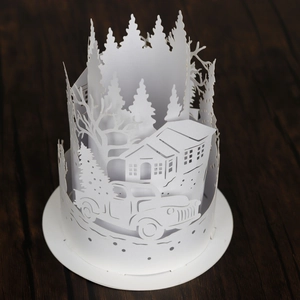 White Christmas tree and pickup truck laser-cut paper lampshade on wooden table