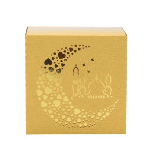 Detail of square gold favor box with moon and mosque cutouts for Ramadan celebration