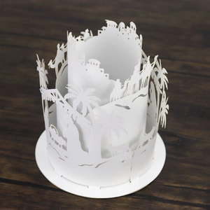 Detailed close-up of a 3D desert-themed hollow paper lampshade with palm trees and camels