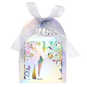 Macro shot of laser-cut wedding candy box with iridescent finish and silver ribbon