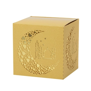 Detail of golden laser-cut candy box with moon, heart, and mosque patterns for Ramadan