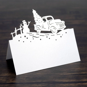 Detailed laser-cut white Christmas place card featuring a vintage truck and snowman