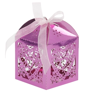 Detailed view of laser-cut heart patterns on purple metallic gift box with pink ribbon