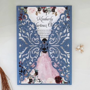 Detail of laser-cut butterfly invitation card with floral interior and elegant pearls
