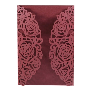 Detailed laser-cut burgundy wedding invitation featuring intricate rose flower patterns