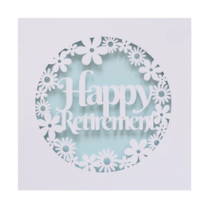 Detail of laser-cut white paper Happy Retirement card with floral pattern and blue layer