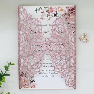 Detail of pink glitter laser-cut rose wedding invitation with elegant floral inner card