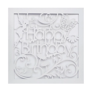 Macro detail of laser-cut butterfly and fairy silhouette pattern on white birthday card