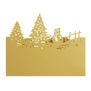 Macro detail of laser-cut golden Christmas card featuring snowman and trees