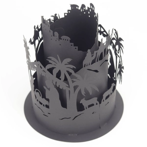Macro detail of 3D cutout lampshade featuring desert camel caravan and palm tree patterns