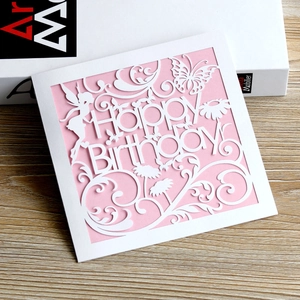Macro detail of laser-cut Happy Birthday card with butterfly and fairy patterns
