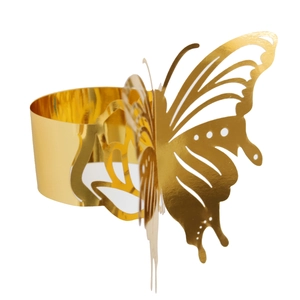 Macro view of golden laser-cut butterfly napkin ring with intricate wing details
