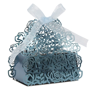 Detailed laser-cut rose pattern on dark blue metallic favor box with light blue ribbon