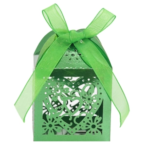 Close-up of laser-cut heart hollow emerald green gift box with matching ribbon bow