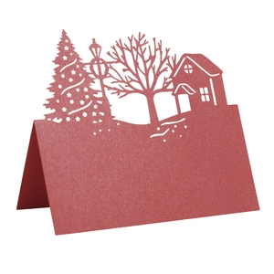 Detailed laser-cut burgundy Christmas place card featuring a hollowed winter tree and house