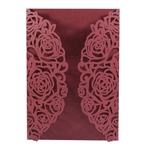 Elegant laser-cut wine red invitation cover with intricate rose floral patterns on matte paper