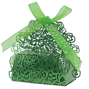 Detail of laser-cut green wedding candy box featuring rose patterns and a silk ribbon