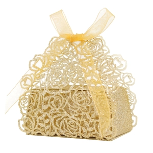 Detailed laser-cut rose pattern on golden glitter wedding favor box with a silk ribbon bow