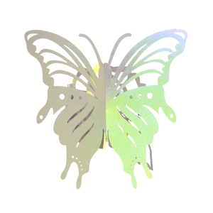 Macro view of laser-cut hollow butterfly napkin rings with a holographic mirror finish