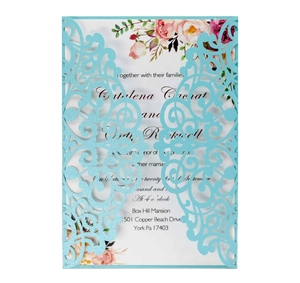 Detail of laser-cut light blue wedding invitation with floral printed insert card