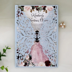 Macro detail of laser-cut butterfly invitation with elegant floral inner card
