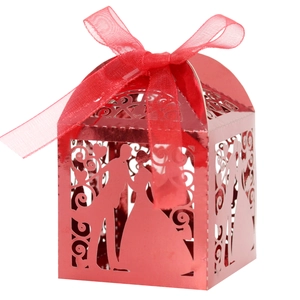 Detail of red laser-cut wedding candy box with bride and groom silhouette and ribbon