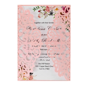 Laser-cut floral wedding invitation with soft pink outer shell and elegant printed insert