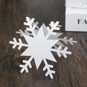 3D white paper snowflake place cards with fold-out design for winter table decor