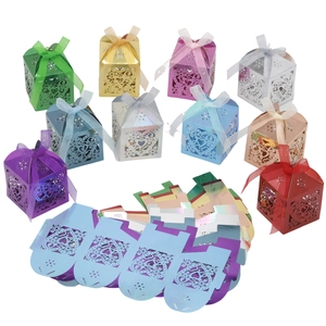 Laser-cut heart favor boxes in multiple colors with matching organza ribbons and flat cards