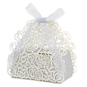 Detail of silver laser-cut rose candy box with glitter finish and a white ribbon bow
